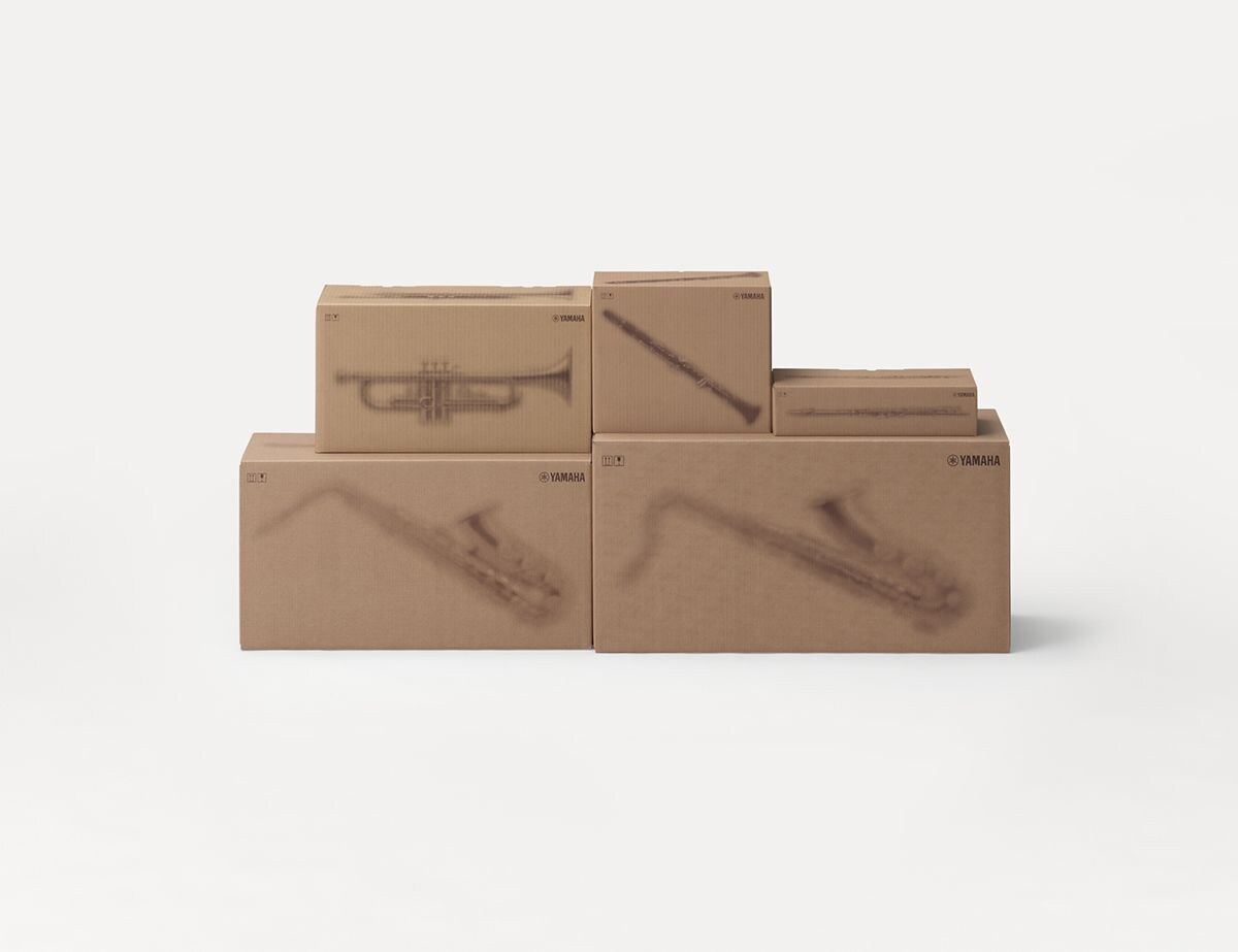 Yamaha cardboard shipping boxes with printed silhouettes of musical instruments.