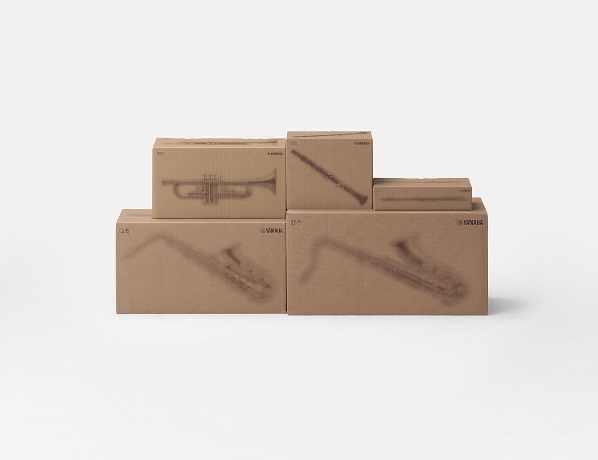 Yamaha cardboard shipping boxes with printed silhouettes of musical instruments.