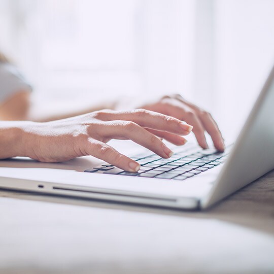 Image of product support, with a person answering inquiries on a conputer